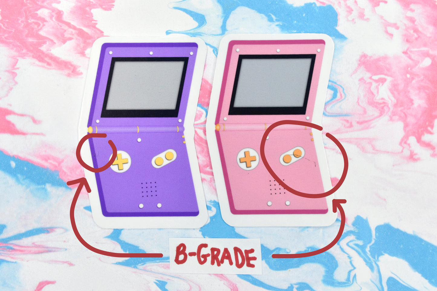 Two b-grade vinyl stickers depicting GameBoy Advances in the non-binary and lesbian pride flag colours respectively.