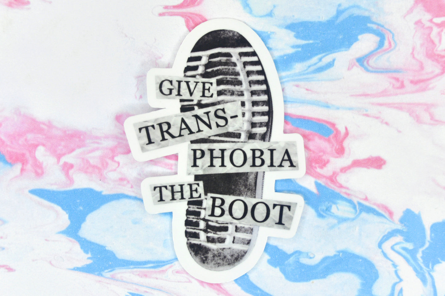 An LGBTQ+ vinyl sticker featuring an illustration of the bottom of a boot with text overlaid reading "give transphobia the boot"