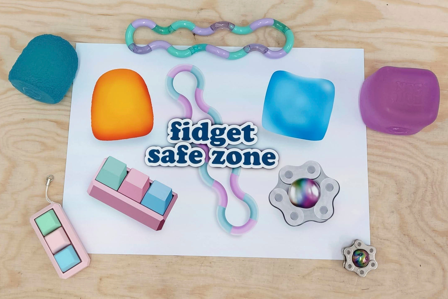 A neurodivergent friendly print depicting various fidget toys with text reading "fidget safe zone" surrounded by real life fidget toys