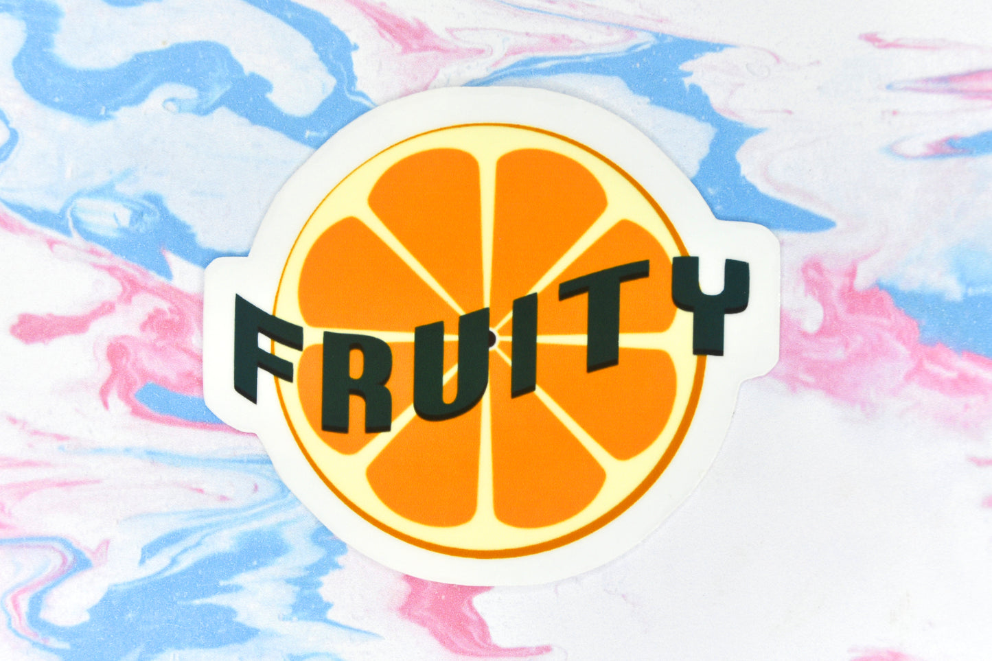 An LGBTQ+ pride vinyl sticker featuring an illustration of an orange with text overlaid reading "Fruity