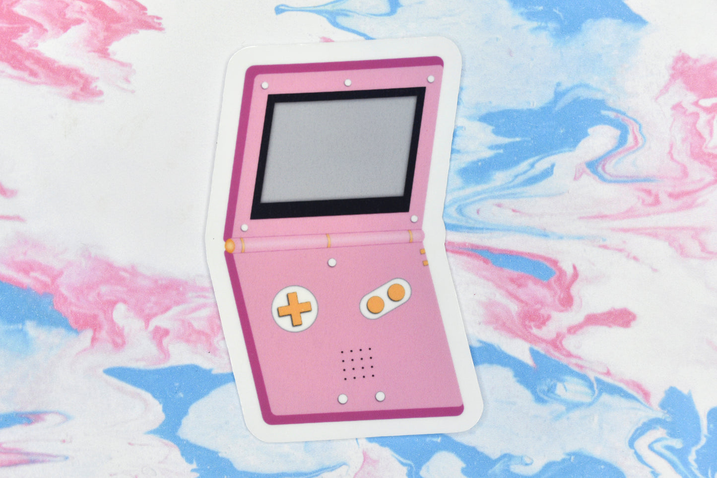 A vinyl sticker depicting a GameBoy Advance in the lesbian pride flag colours.