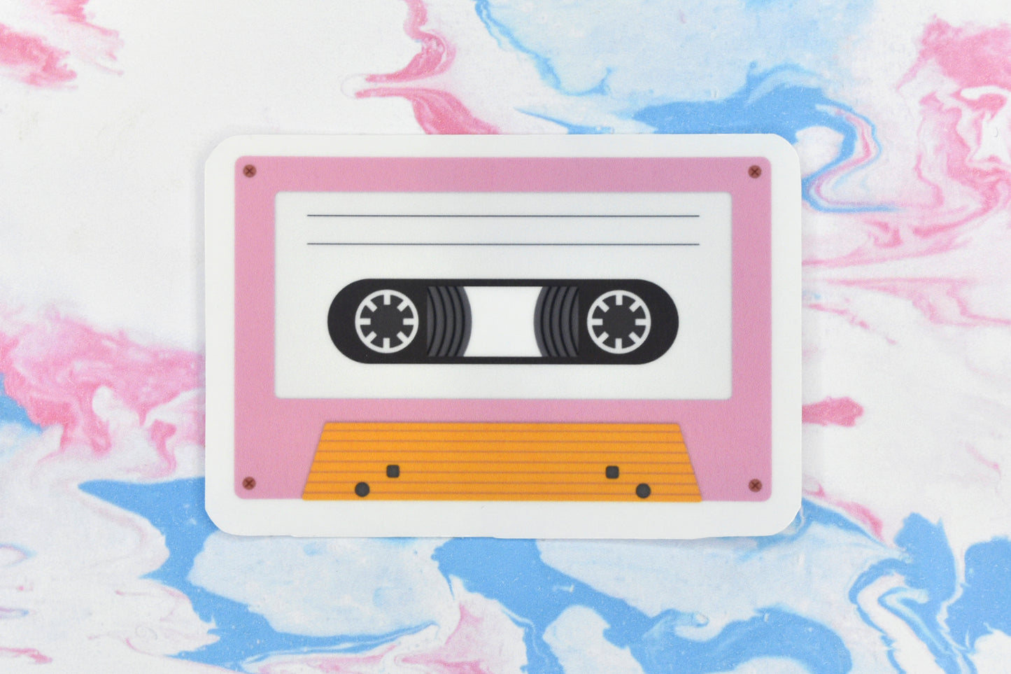 An LGBTQ+ pride vinyl sticker depicting a cassette tape in the lesbian pride flag colours.