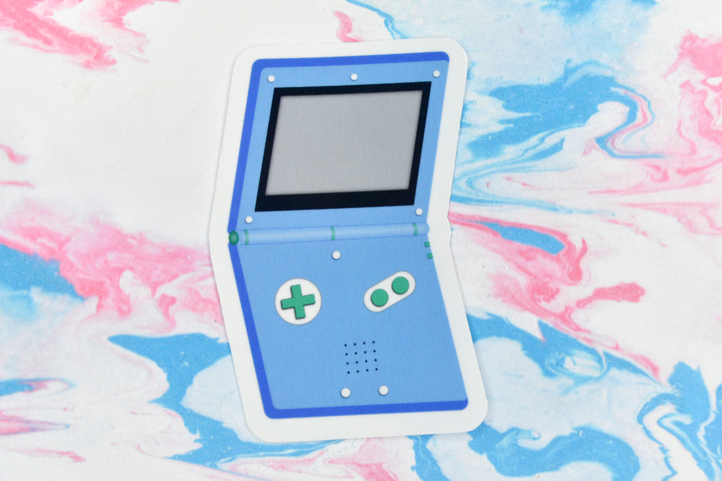A vinyl sticker depicting a GameBoy Advance in the gay MLM pride flag colours.