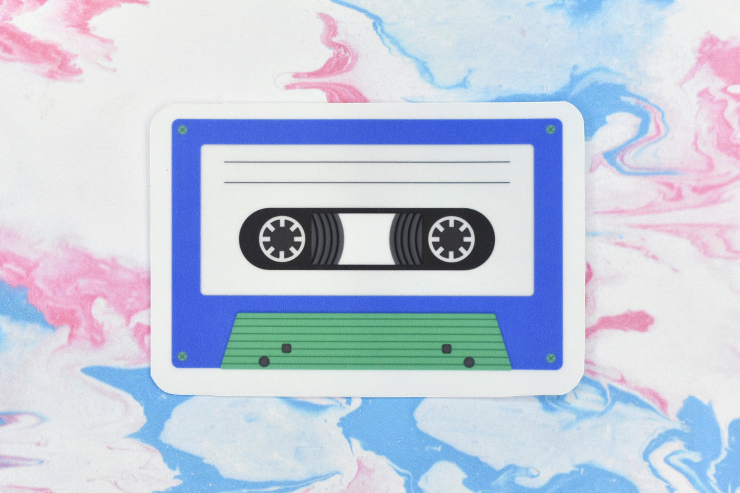 An LGBTQ+ pride vinyl sticker depicting a cassette tape in the gay MLM pride flag colours.