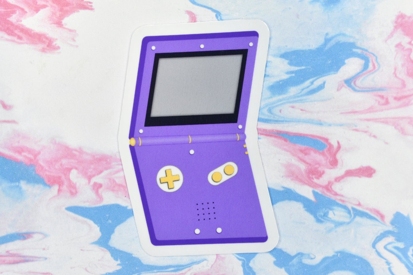 A vinyl sticker depicting a GameBoy Advance in the non-binary pride flag colours.