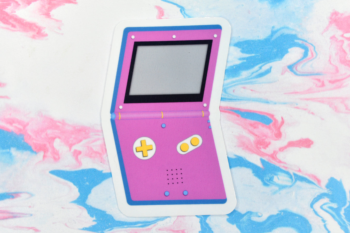A vinyl sticker depicting a GameBoy Advance in the pansexual pride flag colours.