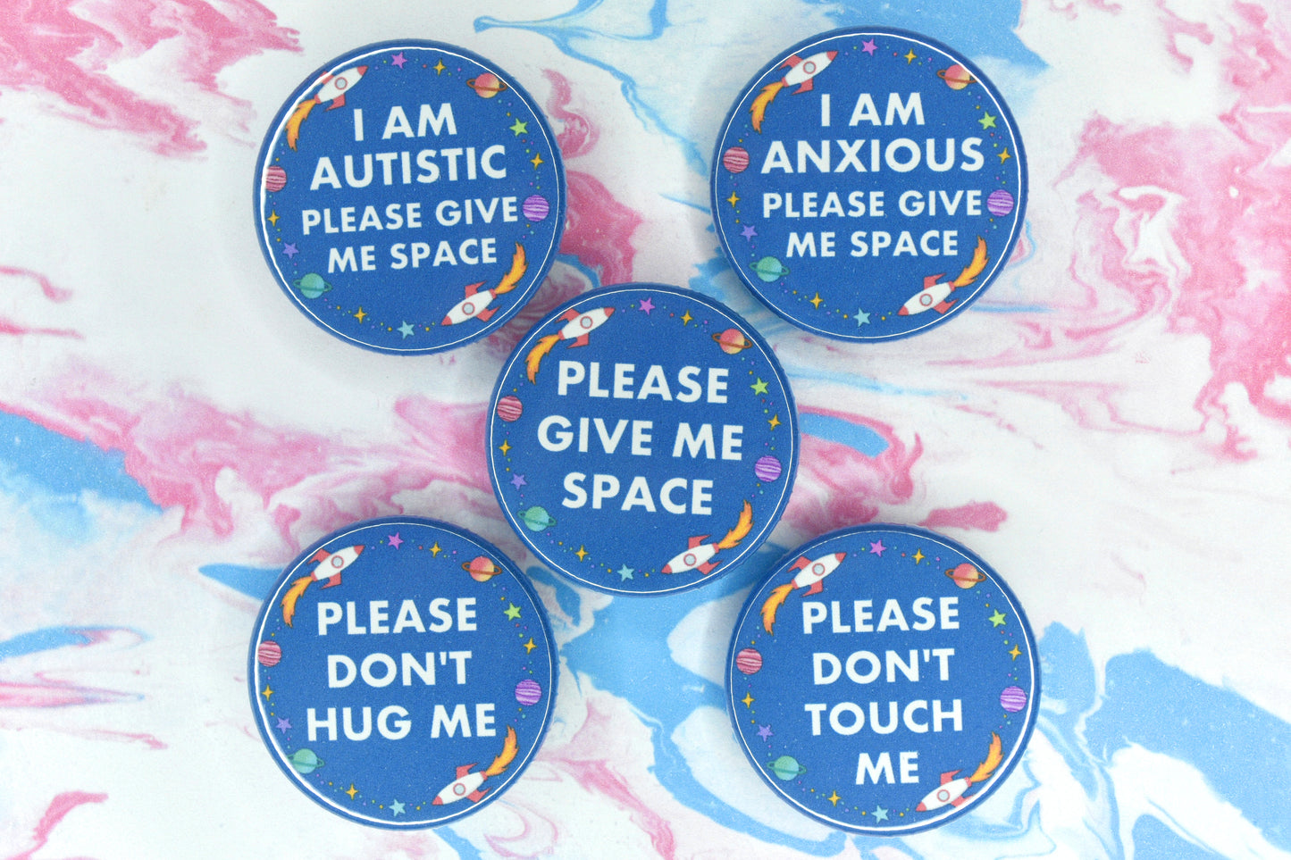 A group of space themed hidden disability badges
