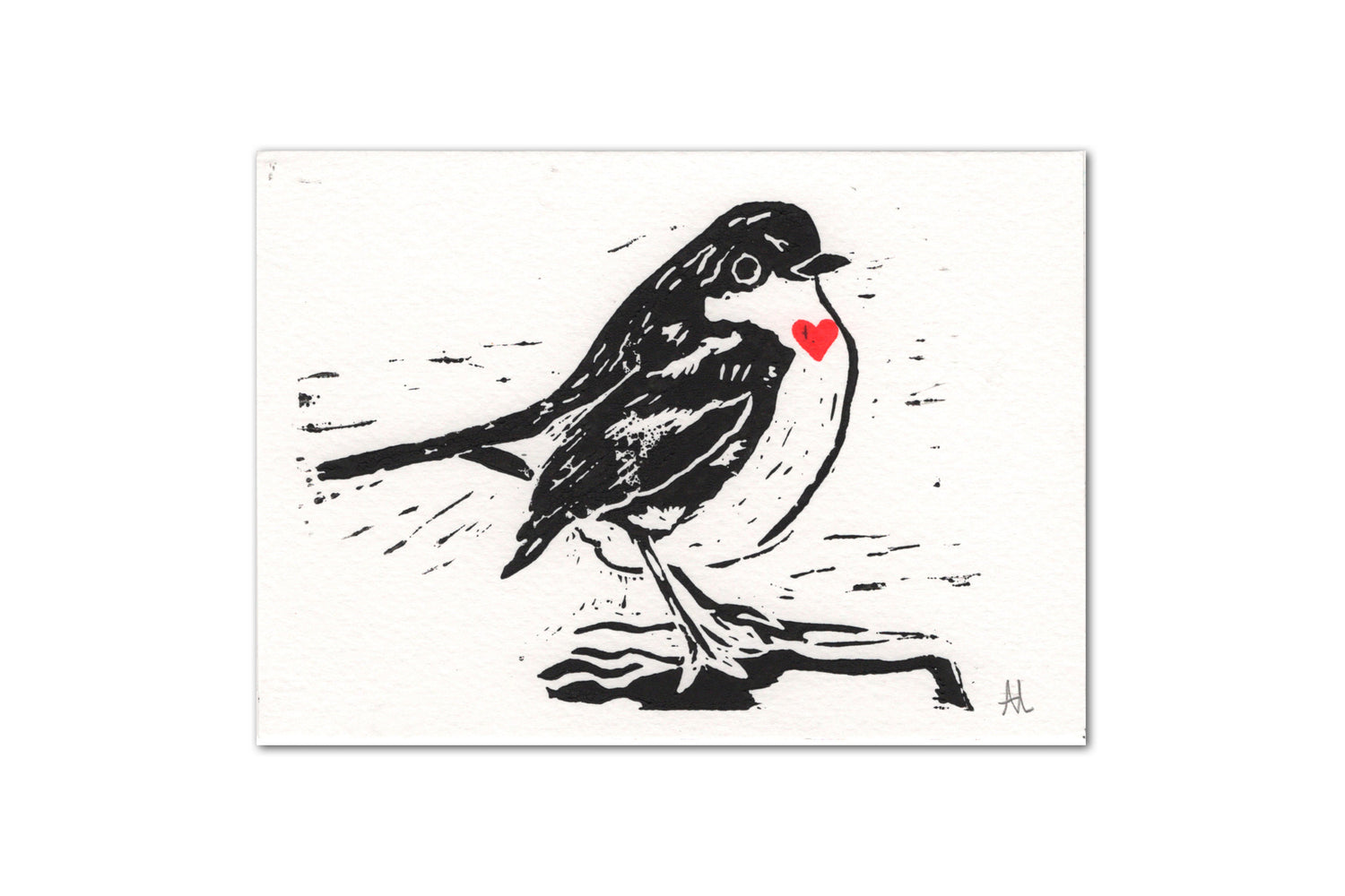 A white landscape card featuring an original lino print of a robin in black ink with a red heart painted on the chest area