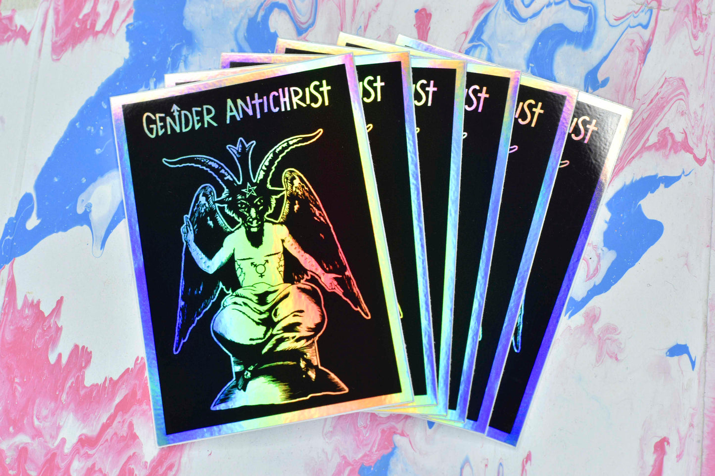 A collection of six Gender Antichrist stickers which are fanned like playing cards.