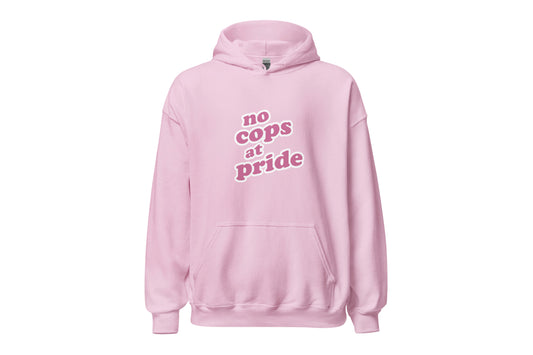 A mock-up of the front of a light pink hoodie featuring dark pink text in a bubble-like font reading "no cops at pride".