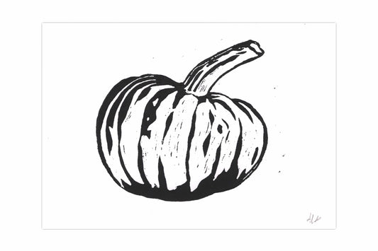 A lino print of a pumpkin, printed in black ink on white card.